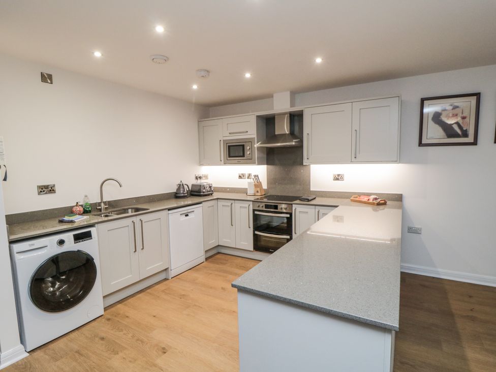 A kitchen with appliances and countertops at Apartment 1, 19 Cleveland Terrace Whitby