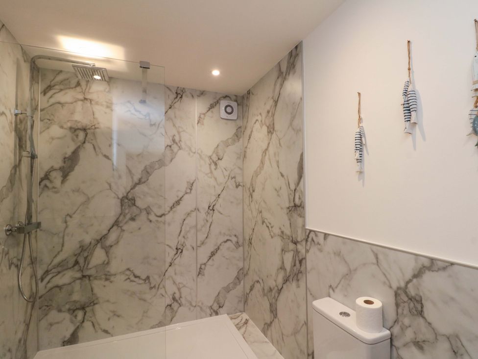 A bathroom with a shower and toilet at Apartment 1, 19 Cleveland Terrace in Whitby