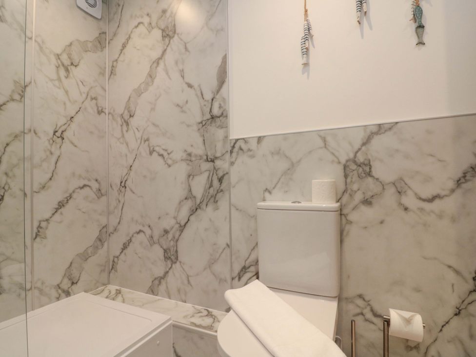 A bathroom featuring a toilet and towel at Apartment 1, 19 Cleveland Terrace in Whitby