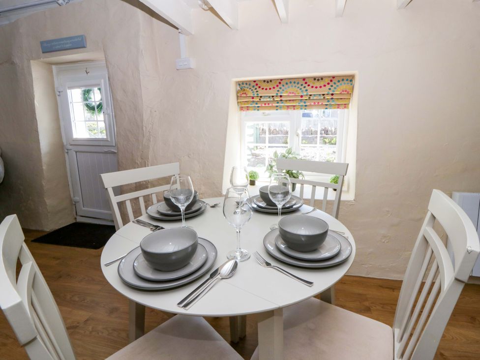 A dining room with a table set for meals at Cobwebs Cold Inn near Saundersfoot