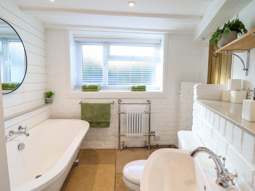 A bathroom with a bathtub and sink at 18 Church Street in Llangollen