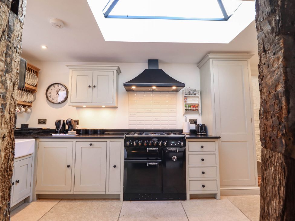 A kitchen with cabinets and oven at 18 Church Street Llangollen