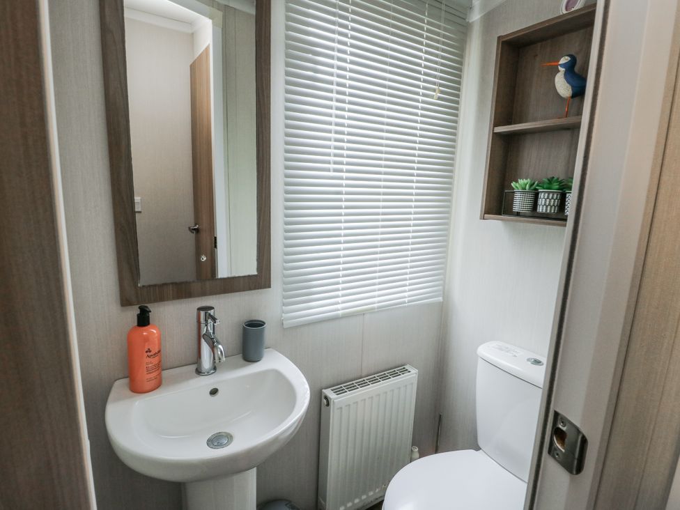 A bathroom with sink and toilet at Trewan Chalet Bryngwran near Rhosneigr