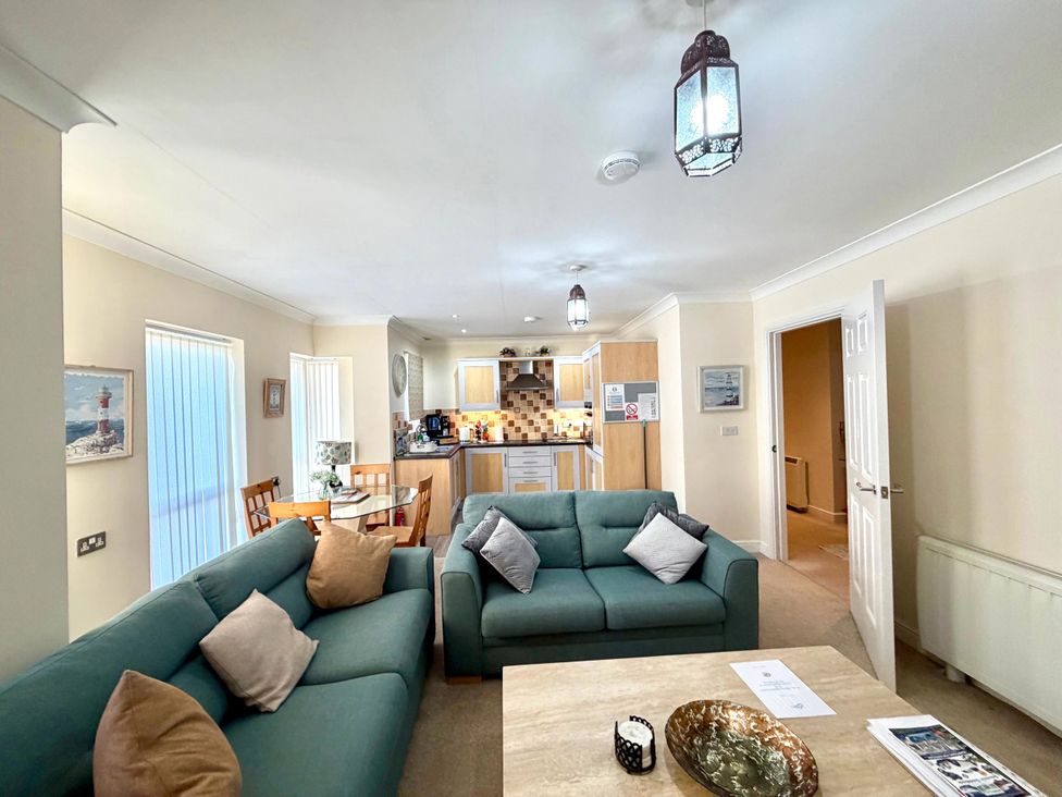 A living room with sofas and dining area at Apartment 1 Middleton near Heysham