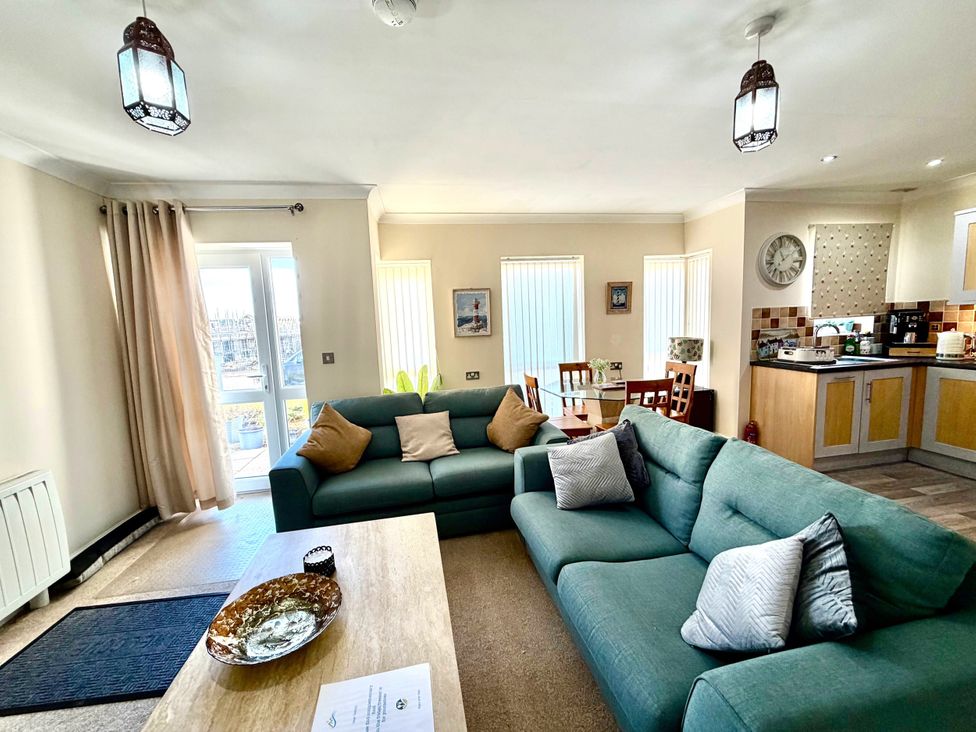 A living room with a sofa and coffee table at Apartment 1 in Middleton near Heysham