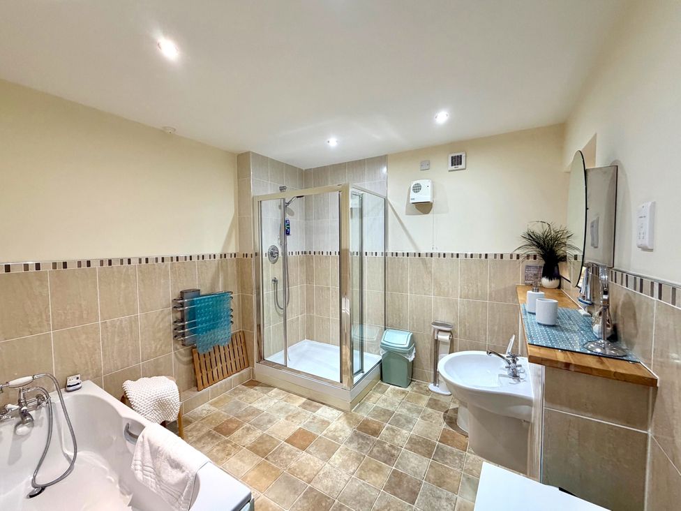 A bathroom with a shower, bathtub, sink, and toilet at Apartment 1 Middleton near Heysham