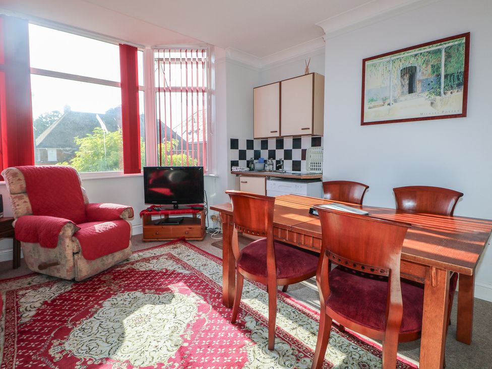 A dining room with a table and chairs at Sylvian in Bexhill-On-Sea