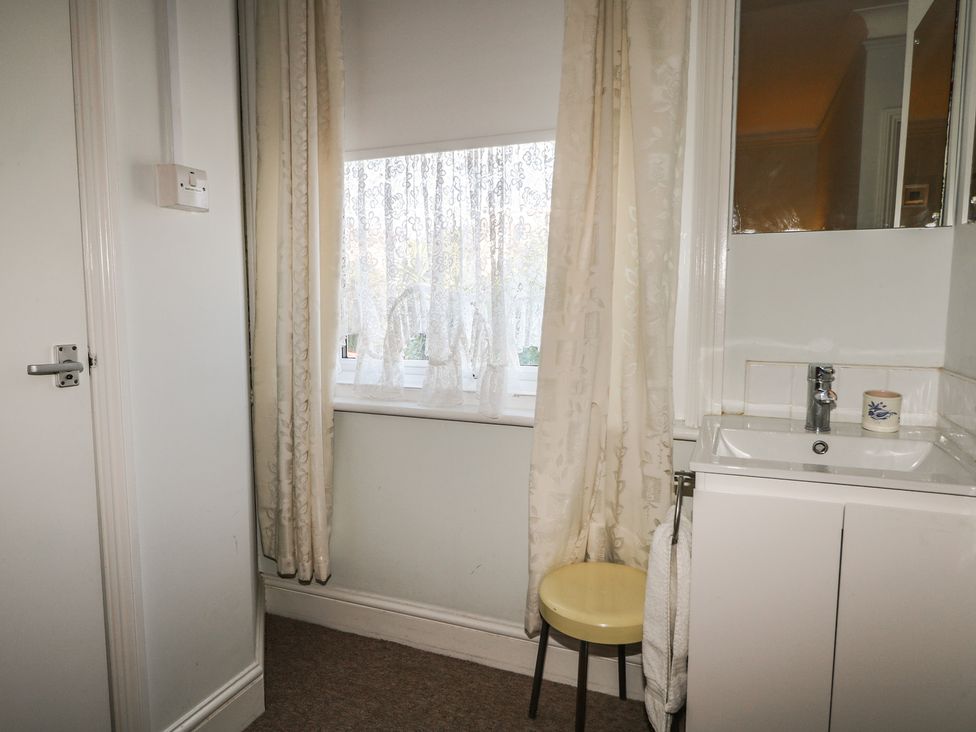 A bathroom with a sink and mirror at Sylvian in Bexhill-On-Sea