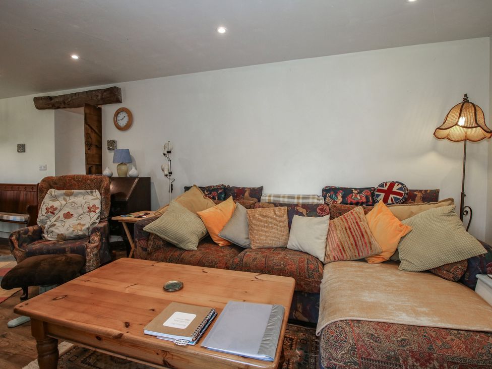 A living room with a sofa and coffee table at Buzzards Breg in Builth Wells