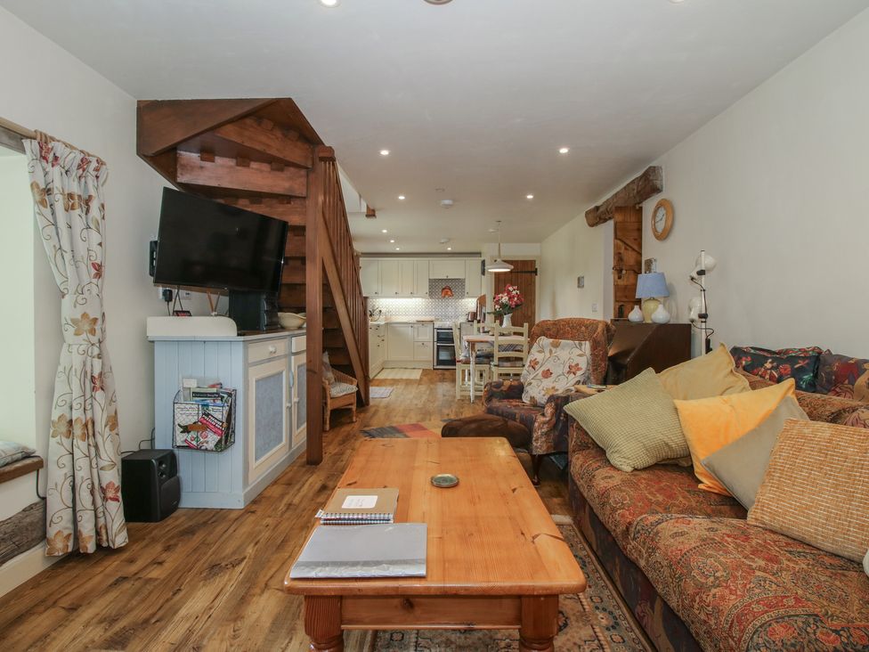 A living room with a sofa and coffee table at Buzzards Breg in Builth Wells