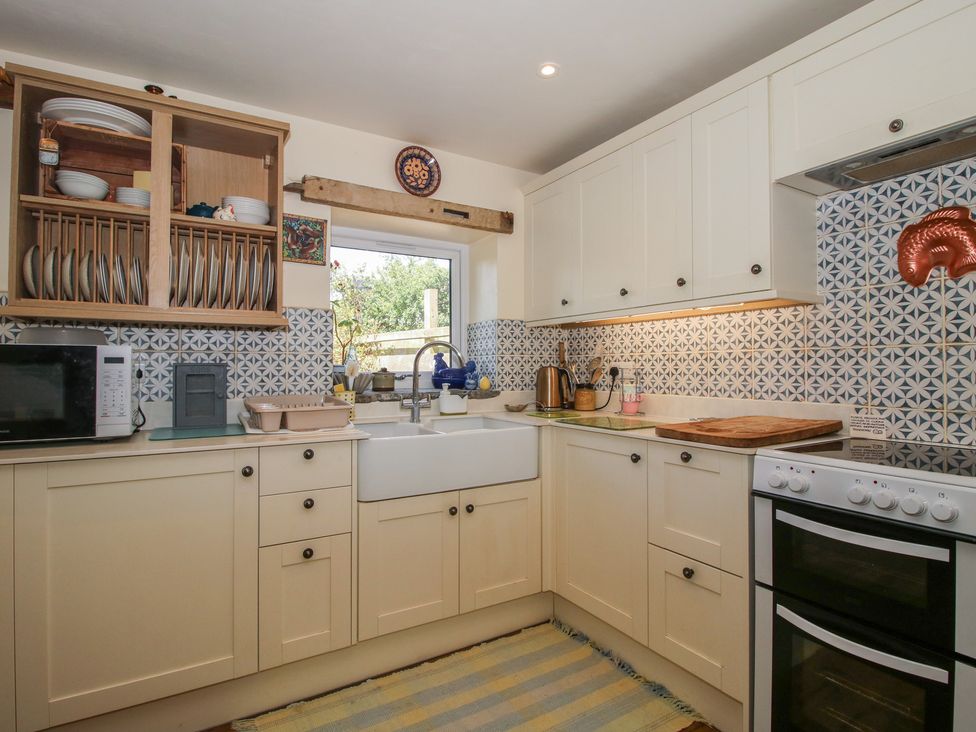 A kitchen with cabinetry and a sink at Buzzards Breg in Builth Wells