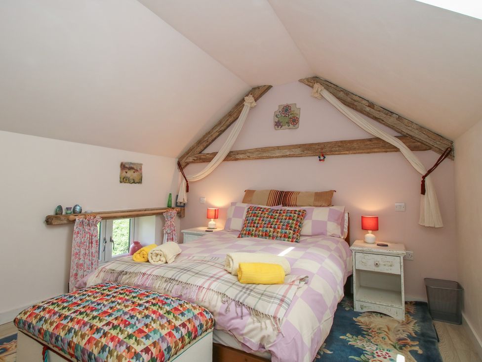 A bedroom with a bed and nightstand at Buzzards Breg in Builth Wells