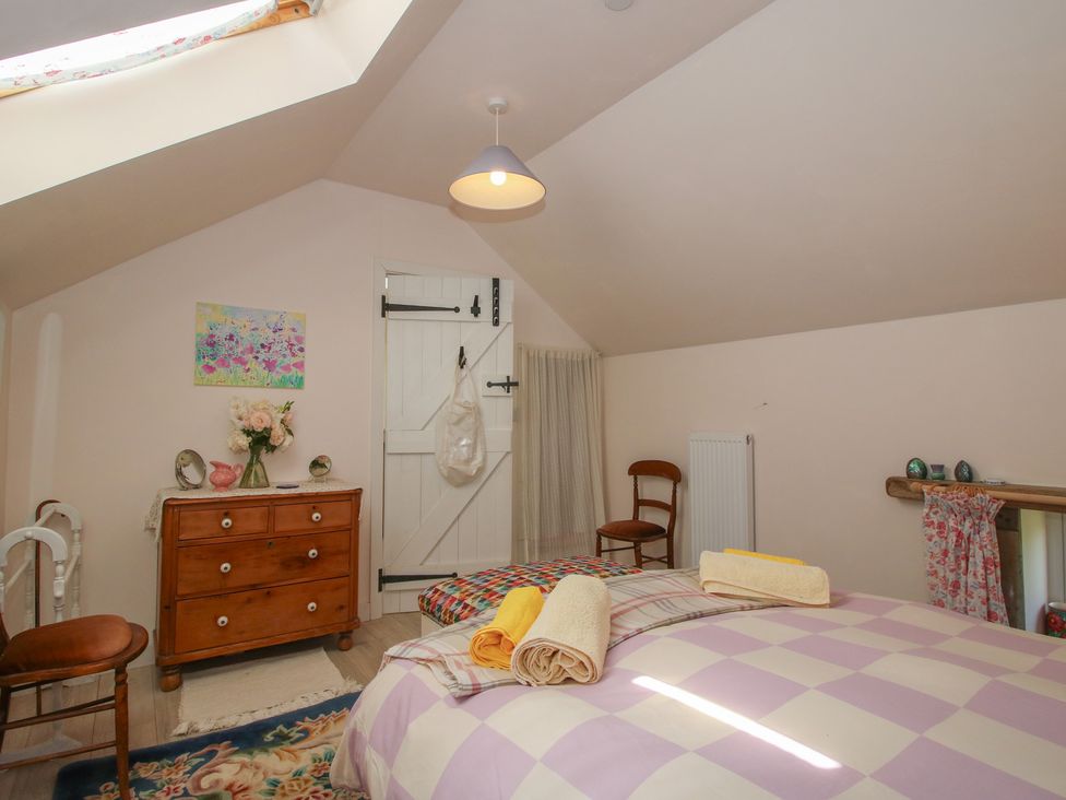 A bedroom with a bed and chest of drawers at Buzzards Breg in Builth Wells