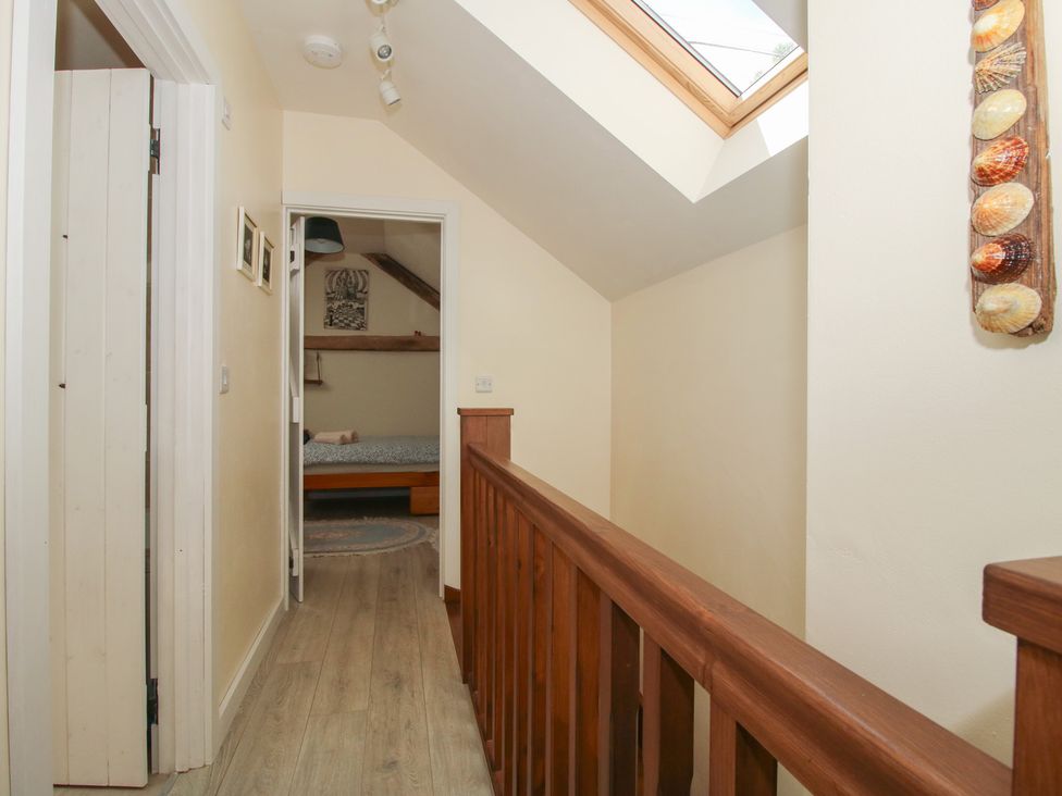 A hallway with a doorway leading to a bedroom at Buzzards Breg in Builth Wells
