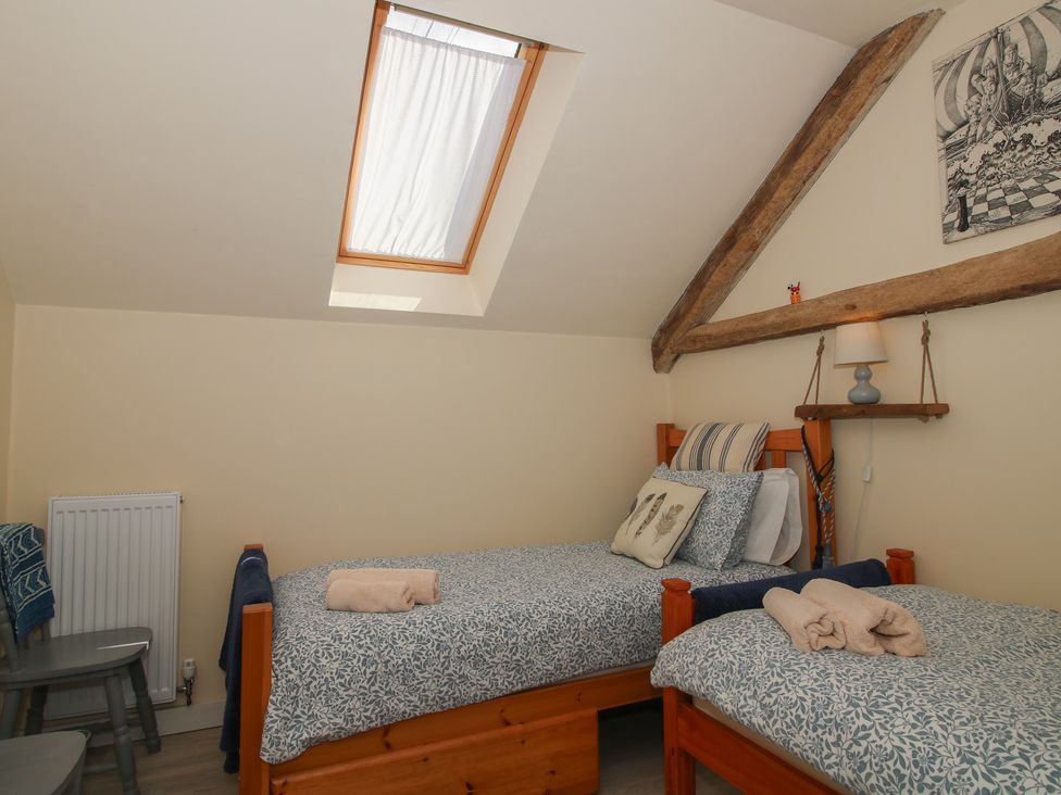 A bedroom with two beds and a skylight at Buzzards Breg, Builth Wells
