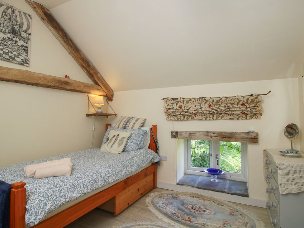 A bedroom with a bed and window at Buzzards Breg in Builth Wells