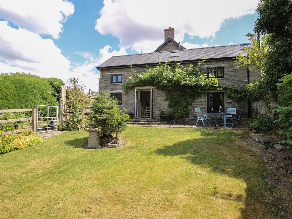A house with a garden and seating area at Buzzards Breg in Builth Wells