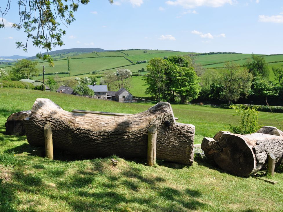 A view of logs and hills at Rockhill Farmhouse in Clun
