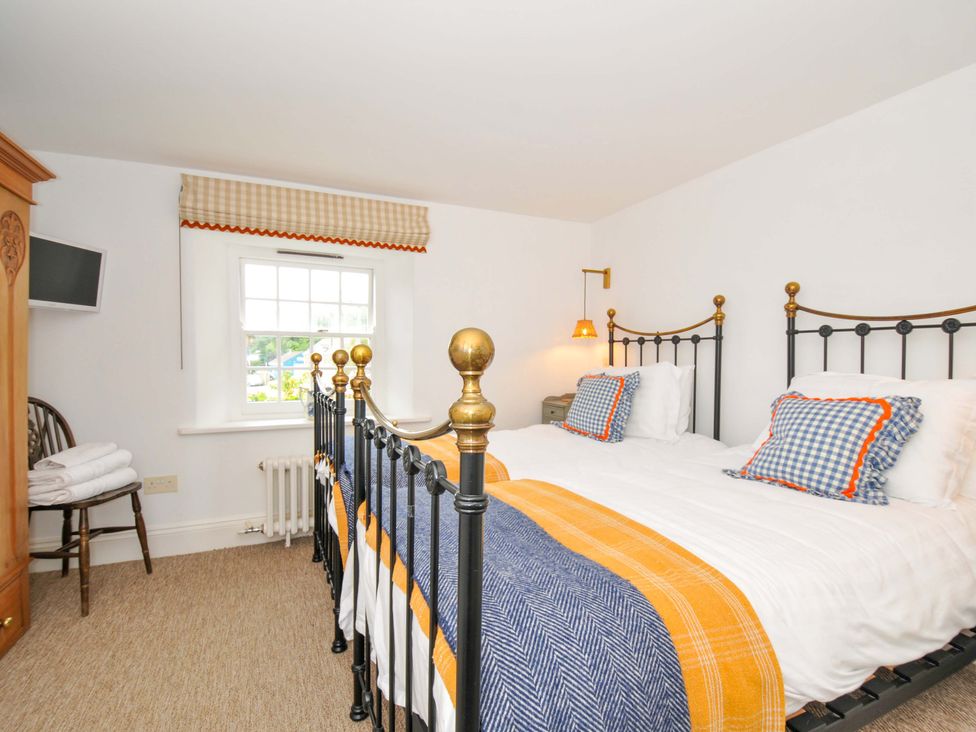 A bedroom with two beds and a window at Island House Golant near Tywardreath