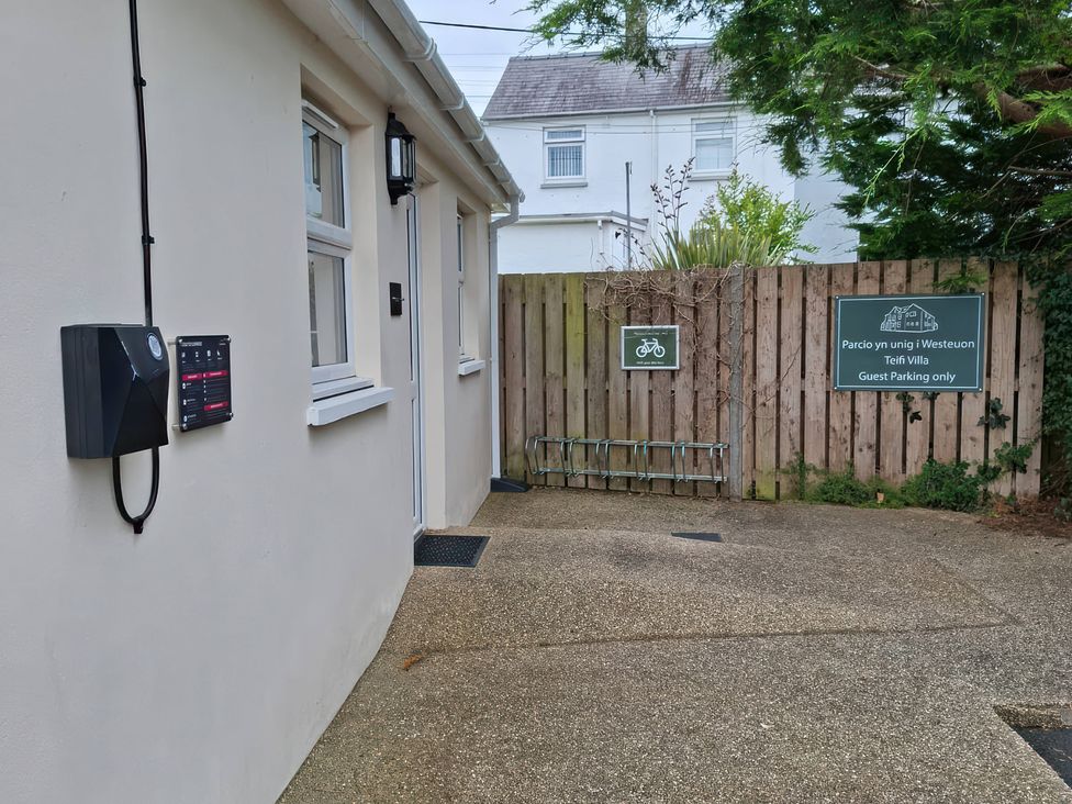 An outdoor area with a gate and a parking sign at Teifi Villa in St Dogmaels