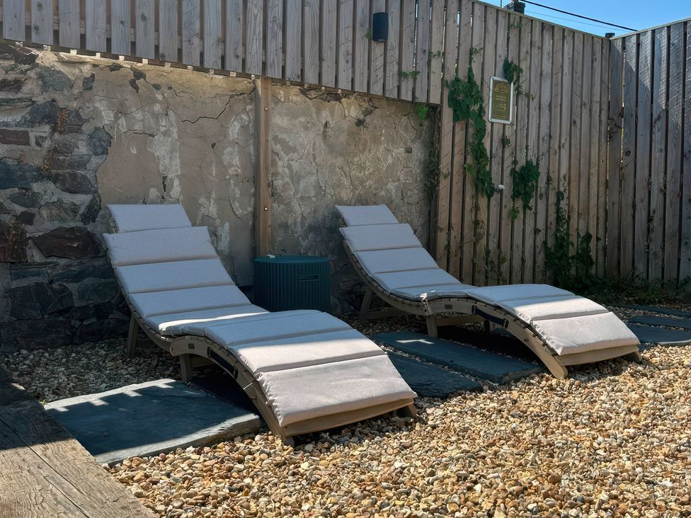 Two loungers on gravel in an outdoor area at Teifi Villa in St Dogmaels