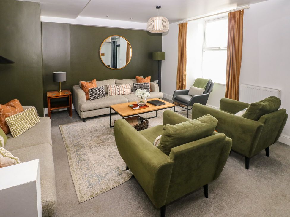 A living room with sofas and a coffee table at Teifi Villa in St Dogmaels