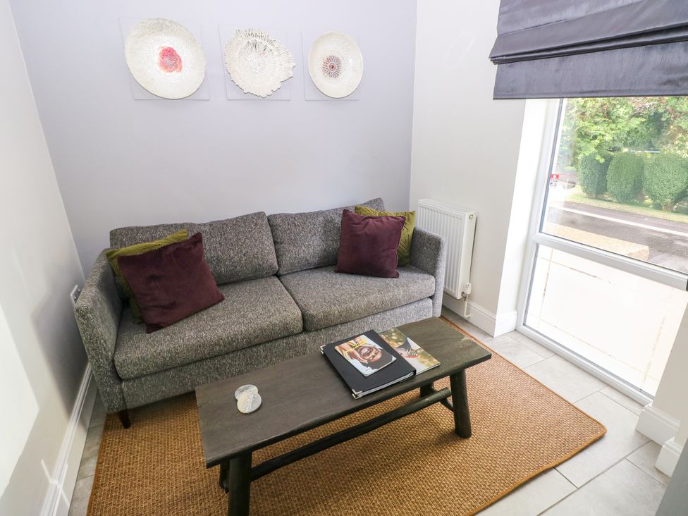 A snug area with a couch and coffee table at Teifi Villa St Dogmaels