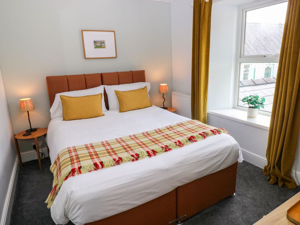 A bedroom with a bed and bedside tables at Teifi Villa in St Dogmaels