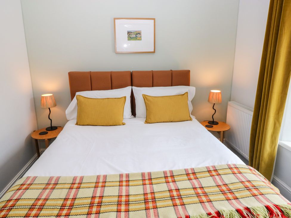 A bedroom with a bed and bedside lamps at Teifi Villa in St Dogmaels