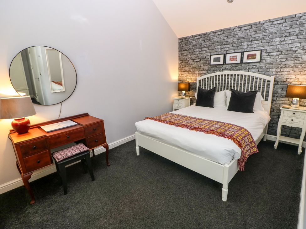 A bedroom with a bed and bedside tables at Teifi Villa in St Dogmaels