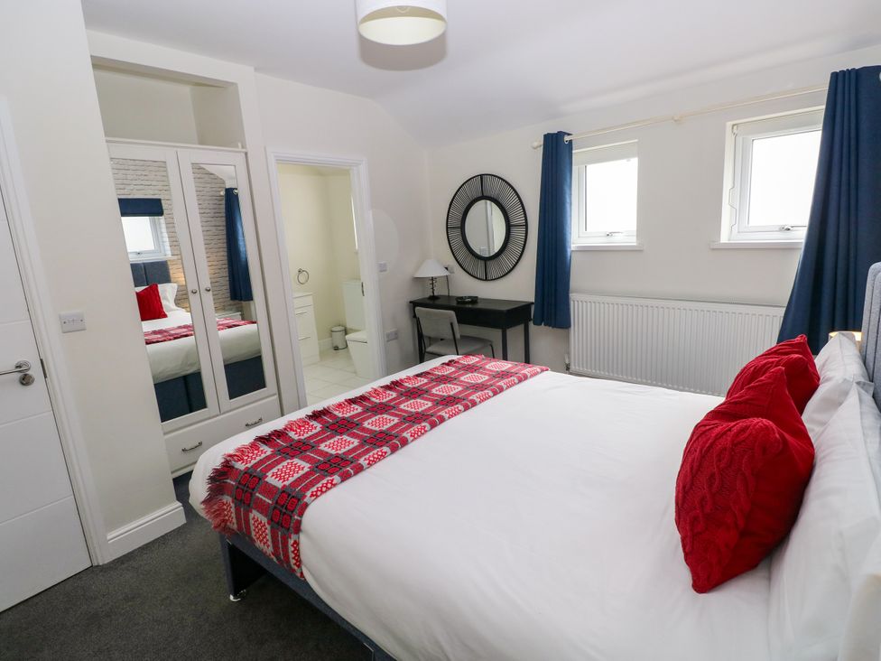A bedroom with a bed and bedside table at Teifi Villa in St Dogmaels