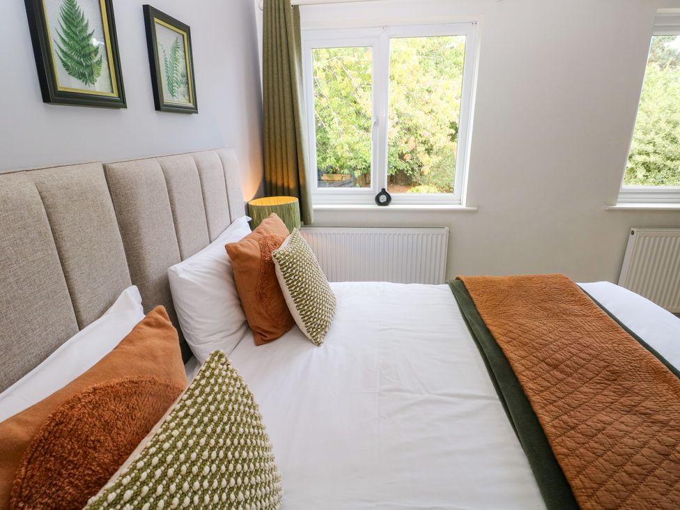 A bedroom with a bed and window at Teifi Villa in St Dogmaels