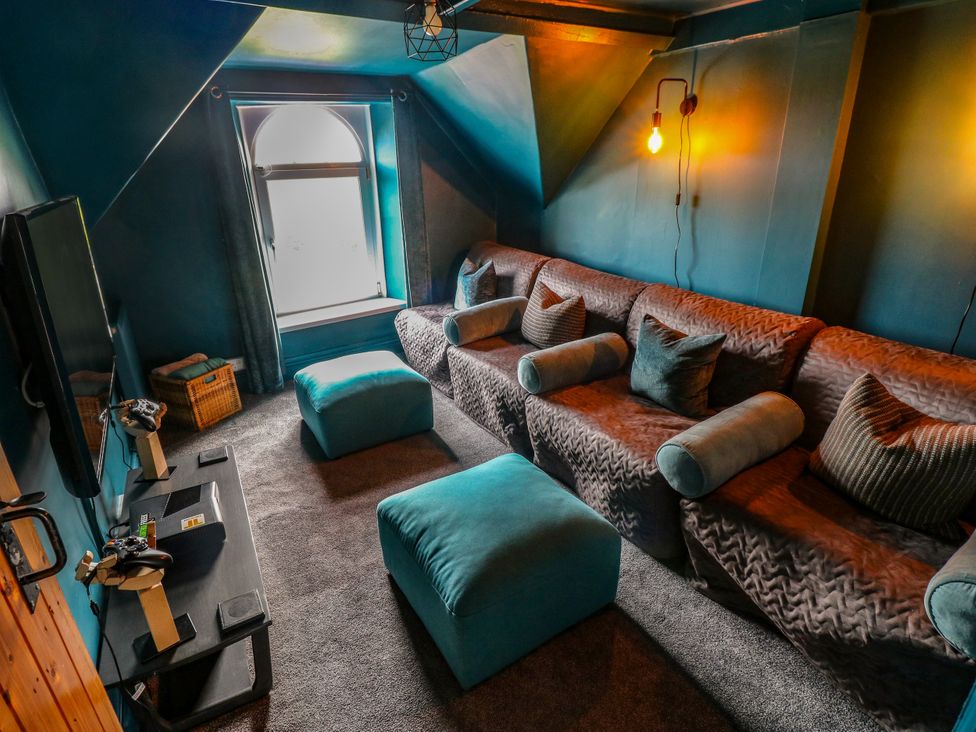 A snug with a sofa and television at Teifi Villa in St Dogmaels