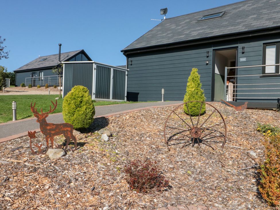 A garden with sculptures and a pathway at Foxes Den in Allerston near Thornton Dale