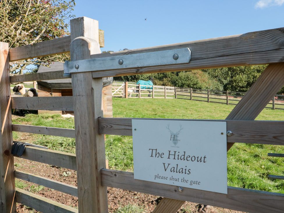 An outdoor area with a gate and sign at The Hideout Valais Allerston near Thornton Dale