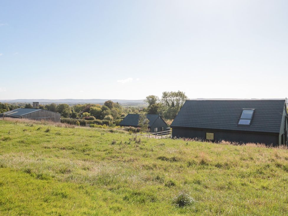 A view of buildings and grass at Foxes Den in Allerston near Thornton Dale