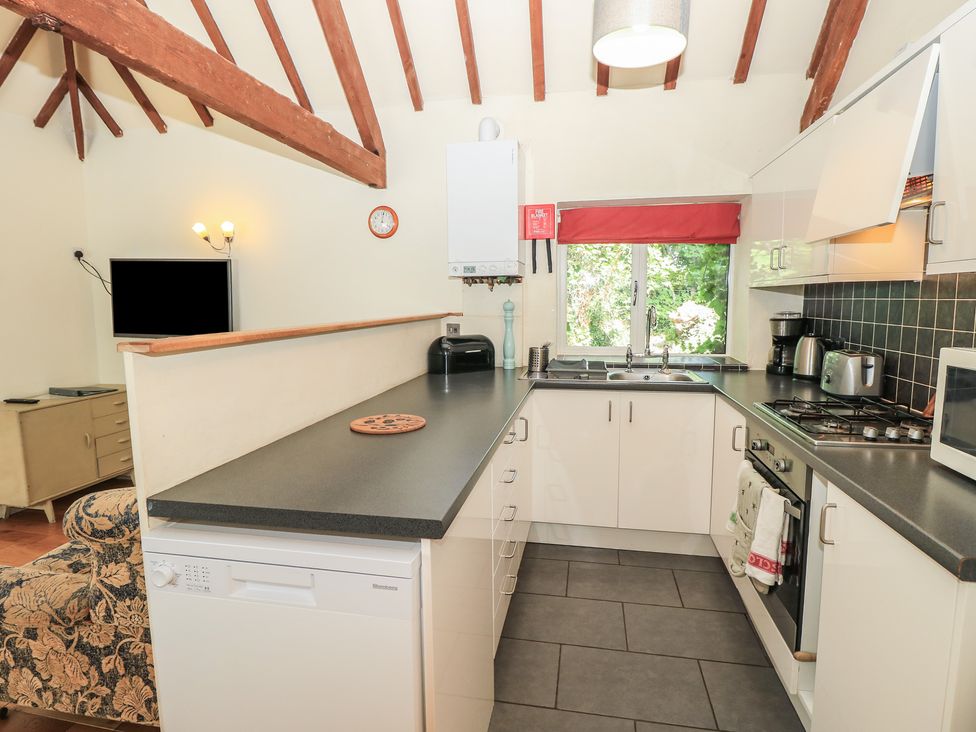A kitchen with various appliances and a countertop at Byre Cottage 4 Sullington near Storrington