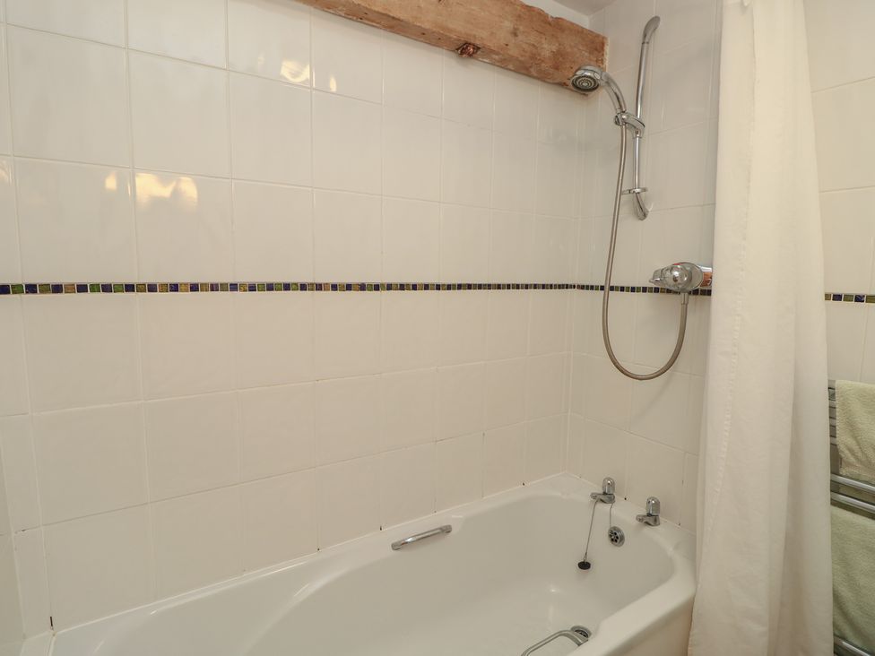A bathroom with a bathtub and shower at Byre Cottage 4 Sullington near Storrington