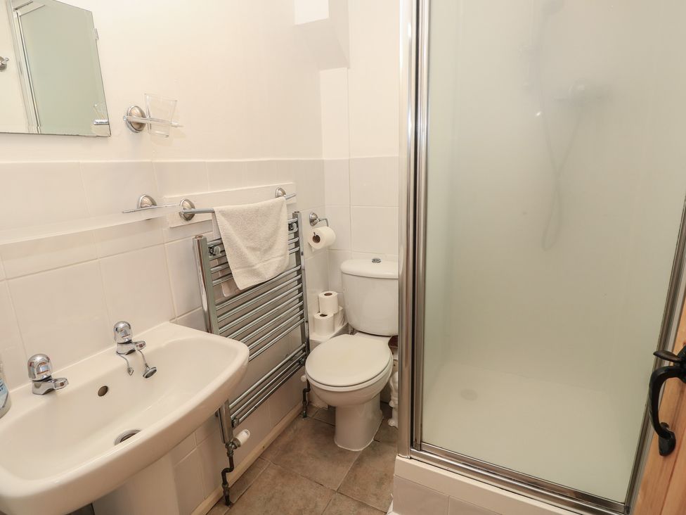 A bathroom with sink, toilet and shower at Byre Cottage 4 Sullington near Storrington