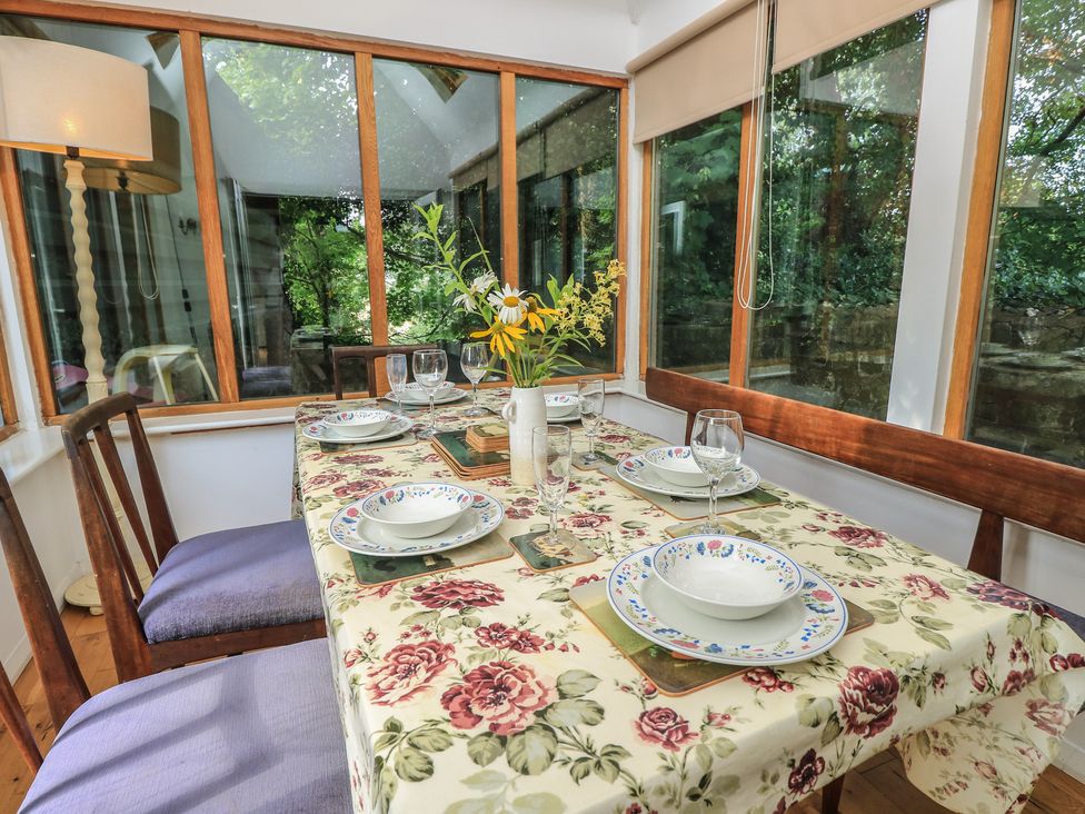 A dining room with a table set for meals at Byre Cottage 4 Sullington near Storrington