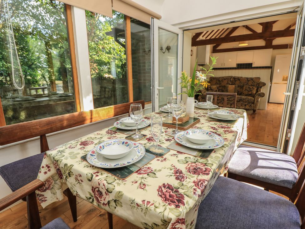A dining room with a table set for a meal at Byre Cottage 4 Sullington near Storrington