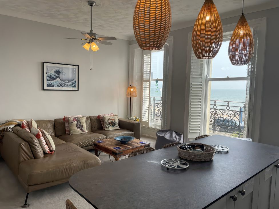 A living room with a sofa and coffee table at Sunrise Apartment in Weymouth