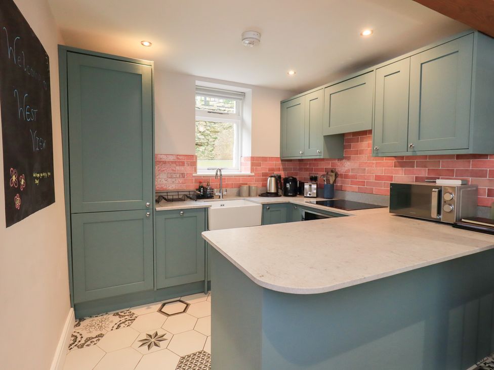 A kitchen with cabinets and appliances at West View in Leasgill near Milnthorpe