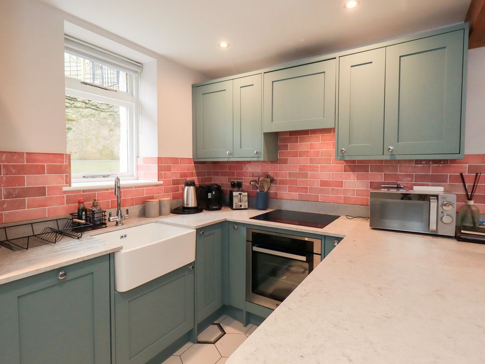 A kitchen with a sink, oven, and microwave at West View in Leasgill near Milnthorpe