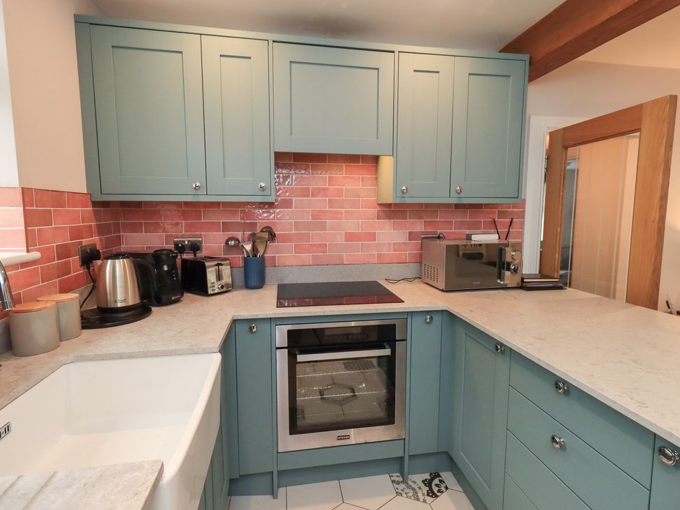 A kitchen with cabinets and appliances at West View in Leasgill near Milnthorpe