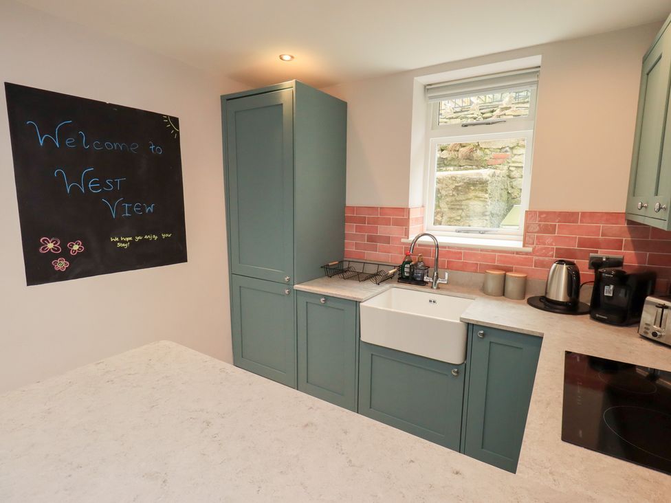 A kitchen with a sink and appliances at West View in Leasgill near Milnthorpe