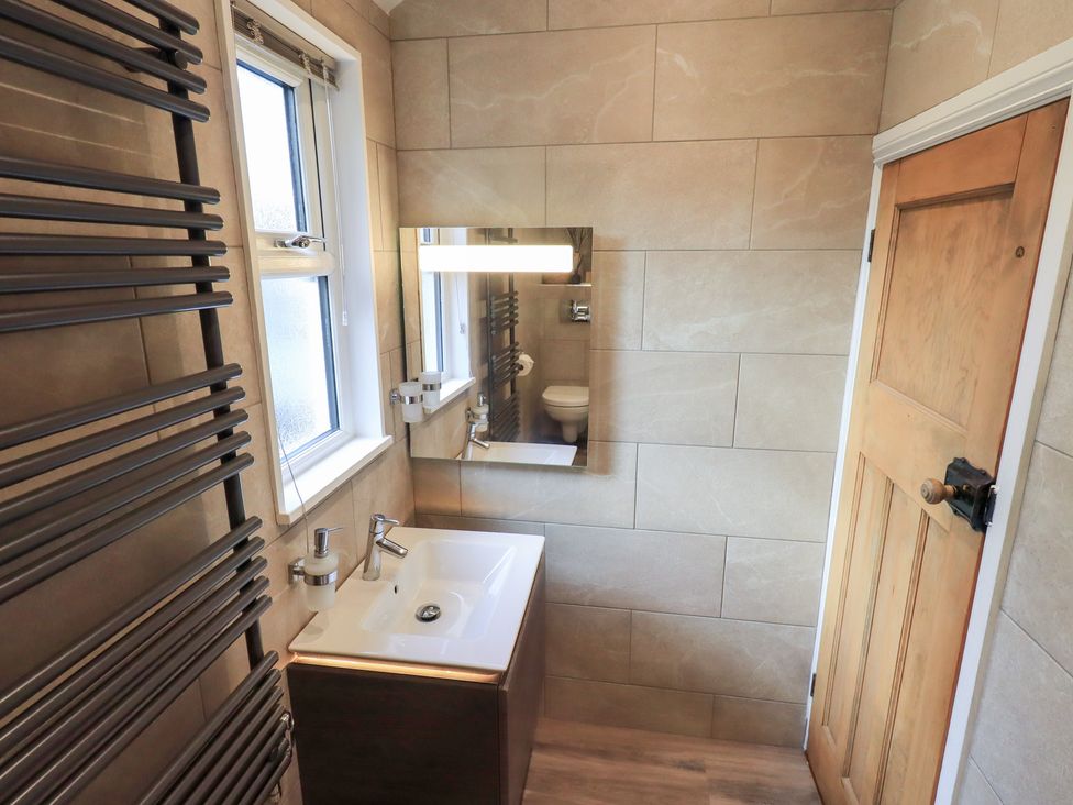 A bathroom with a sink and towel radiator at West View in Leasgill near Milnthorpe