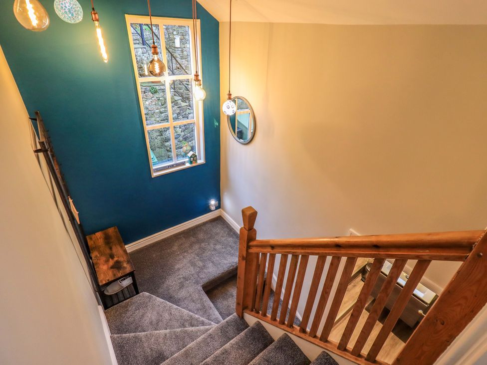 A staircase with a window and lighting fixtures at West View in Leasgill near Milnthorpe
