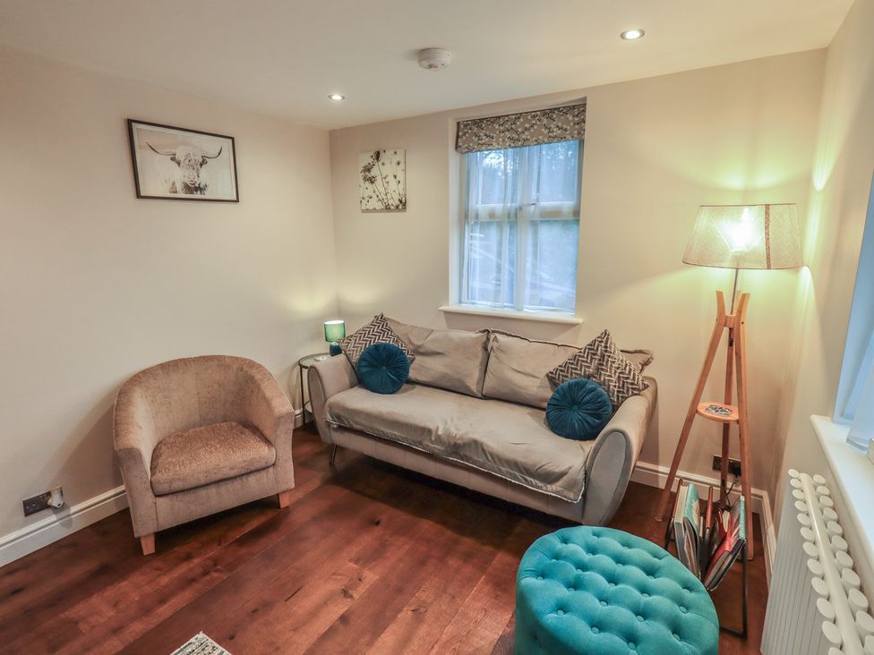 A living room with a sofa and lamp at West View Leasgill near Milnthorpe