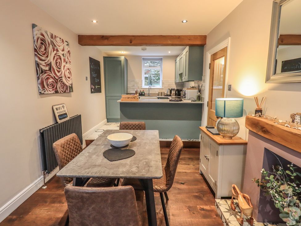 A dining room with a table and chairs at West View in Leasgill near Milnthorpe